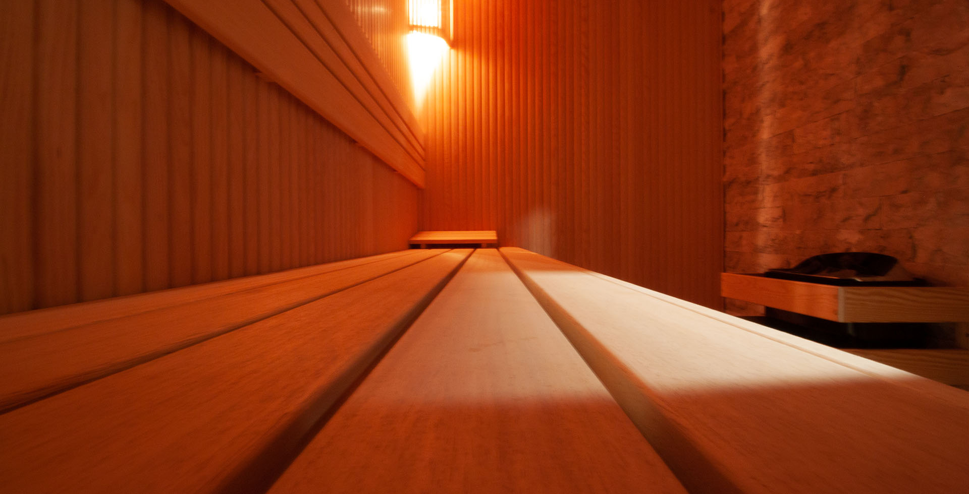 Close-up view of a sauna interior in Amsterdam, showcasing the detailed wooden architecture, warm lighting, and inviting atmosphere for a truly immersive experience.